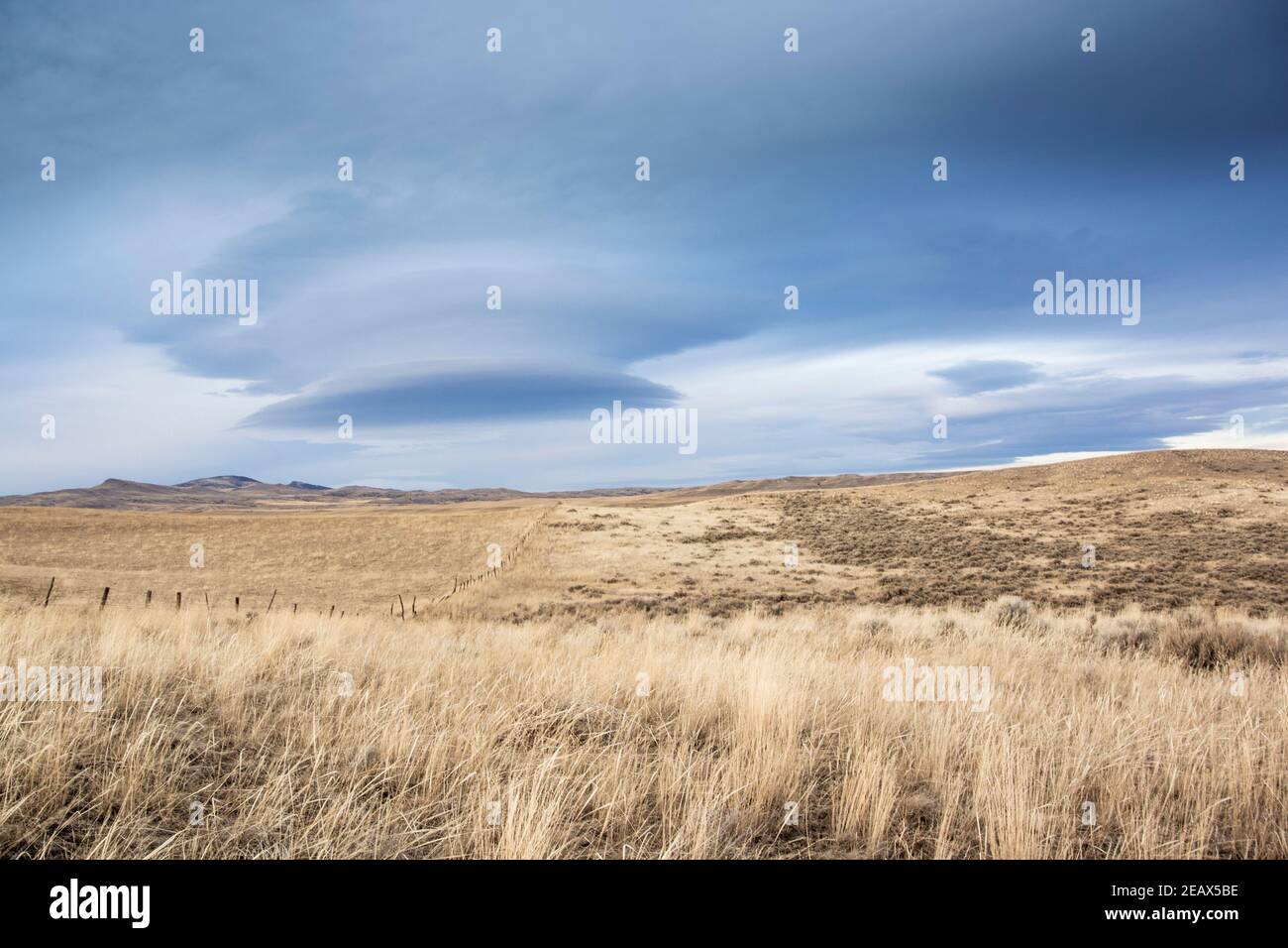 Lenticular clouds over the rolling landscape, near Milligan Canyon, in Jefferson County, Montana Stock Photo