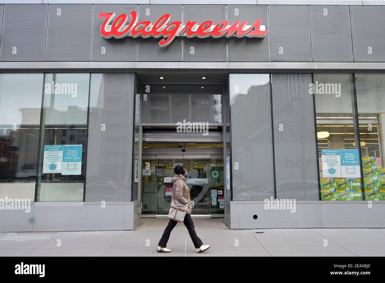 New York, USA. 10th Feb, 2021. A woman walks past the entrance to a