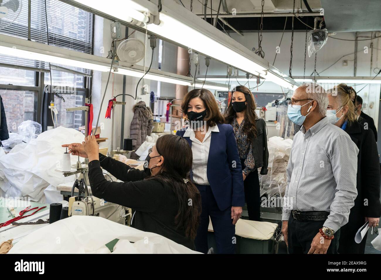 New York, United States. 10th Feb, 2021. LG Kathy Hochul visits Four Seasons Fashion as part of women-owned nonprofit Garment District for Gowns on 39th street of Manhattan in New York on February 10, 2021. LG was touring Four Season Fashion company owned by Tony Singh (R). LG observes how seamstress works on sewing gown. (Photo by Lev Radin/Sipa USA) Credit: Sipa USA/Alamy Live News Stock Photo