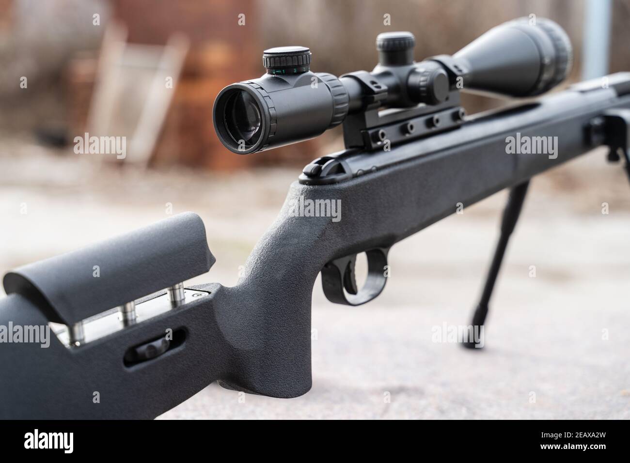 Black polymer frame modern Air gun with optics on the table outdoor Stock Photo