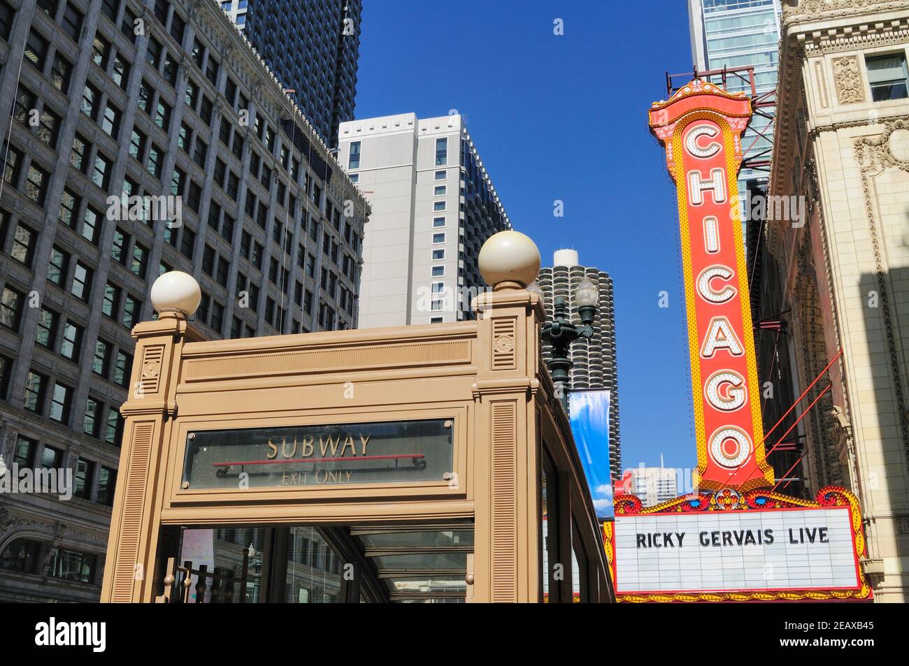 Chicago, Illinois, USA. Two city symbols, a subway exit portal on State Street by a local landmark, the Chicago Theatre. Stock Photo