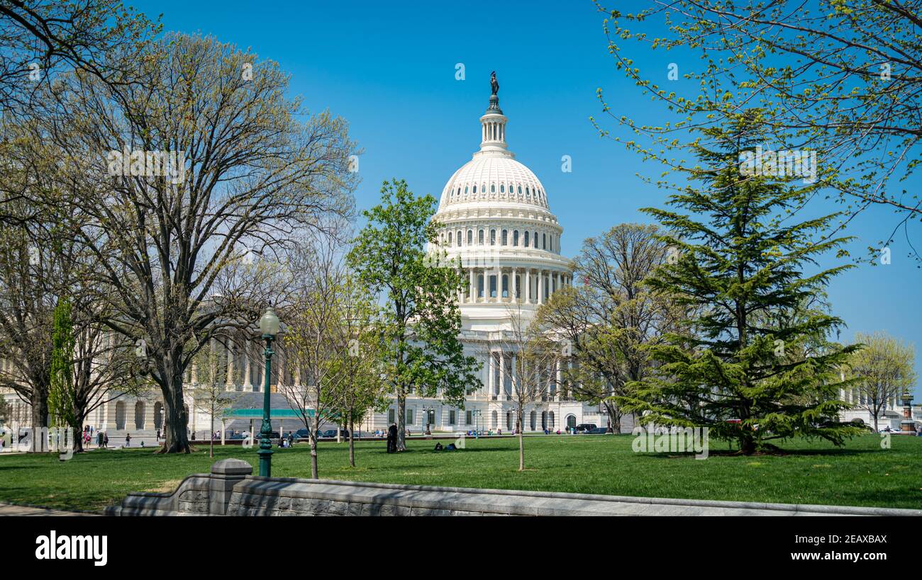 The U.S. Capitol Building stands aganst a clear blue sky on a sunny day. Stock Photo