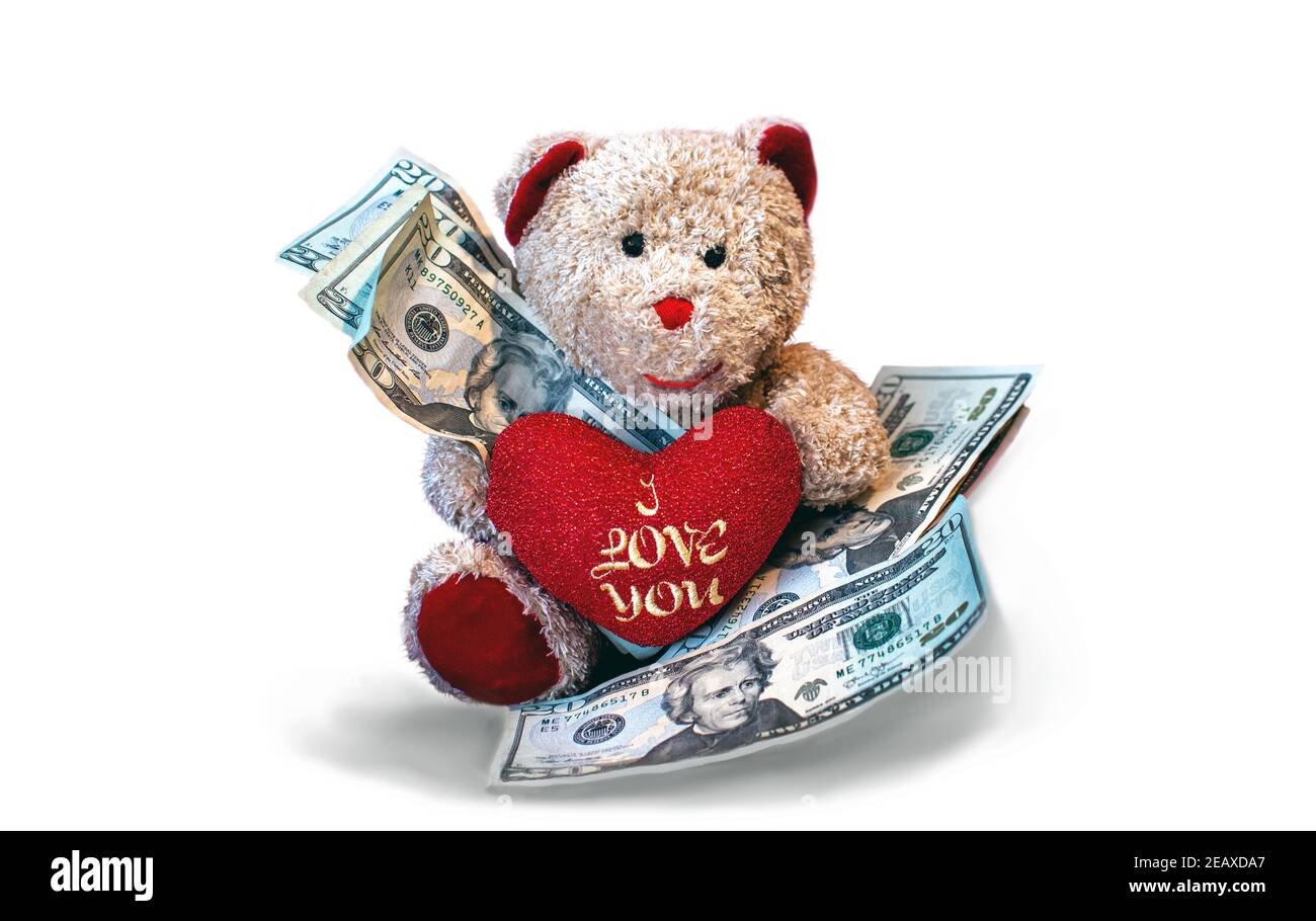 Teddy bear with a I love you heart holds American currency to illustrate the cost of love Stock Photo