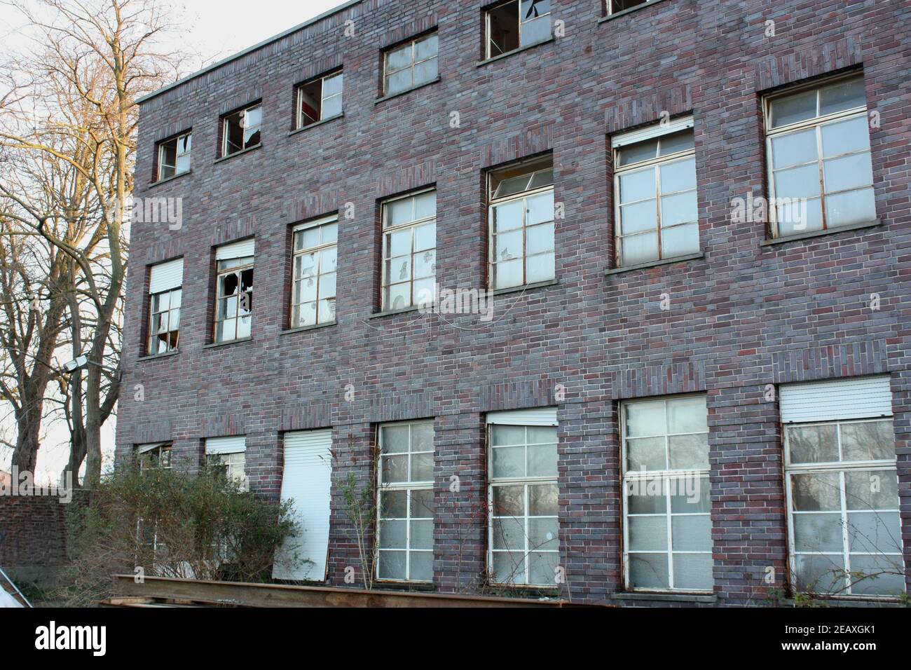 View of an abandoned brick-walled building with glass windows Stock ...