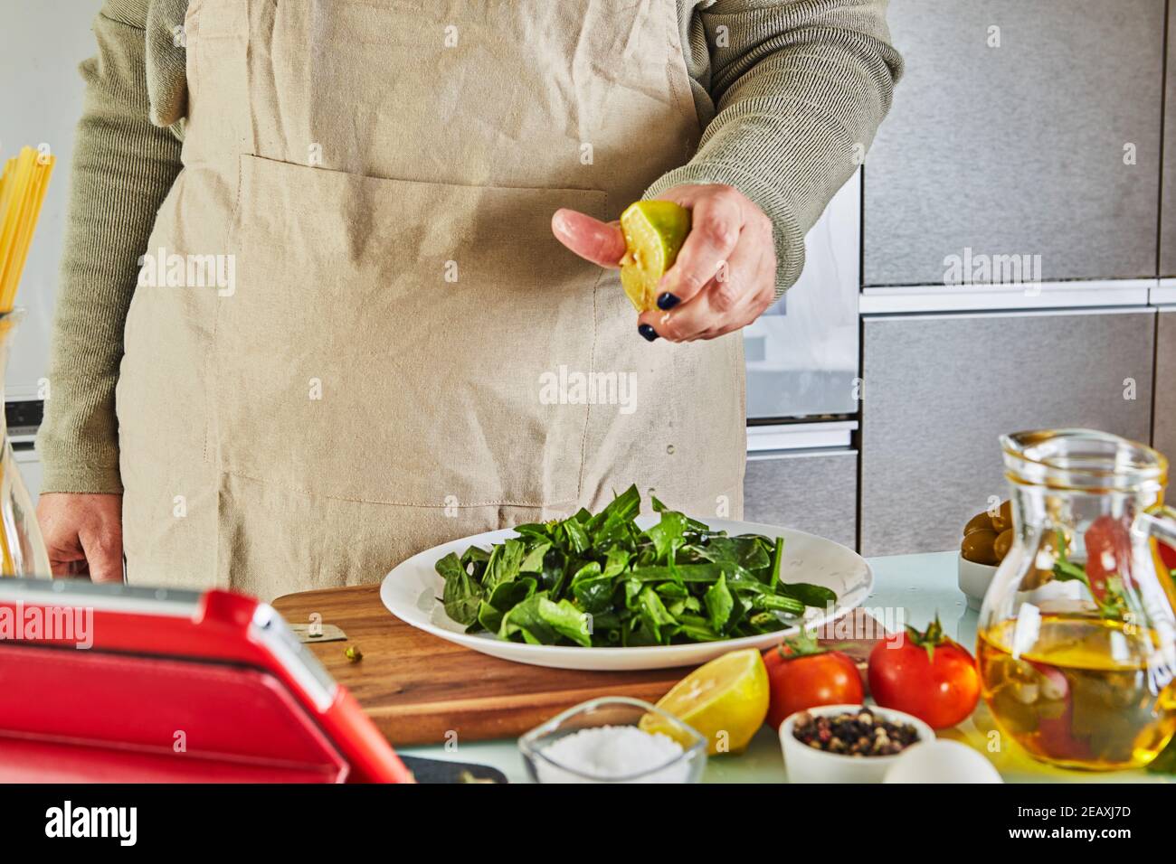 Woman cooking according the tutorial of online virtual master class ...