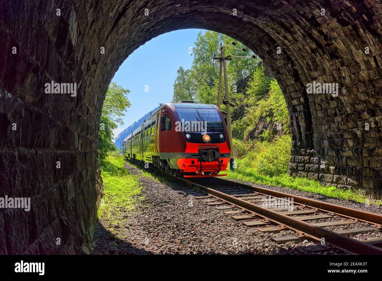 A commuter train pulls into a tunnel. Circum-Baikal Railway. Irkutsk region. Eastern Siberia Stock Photo