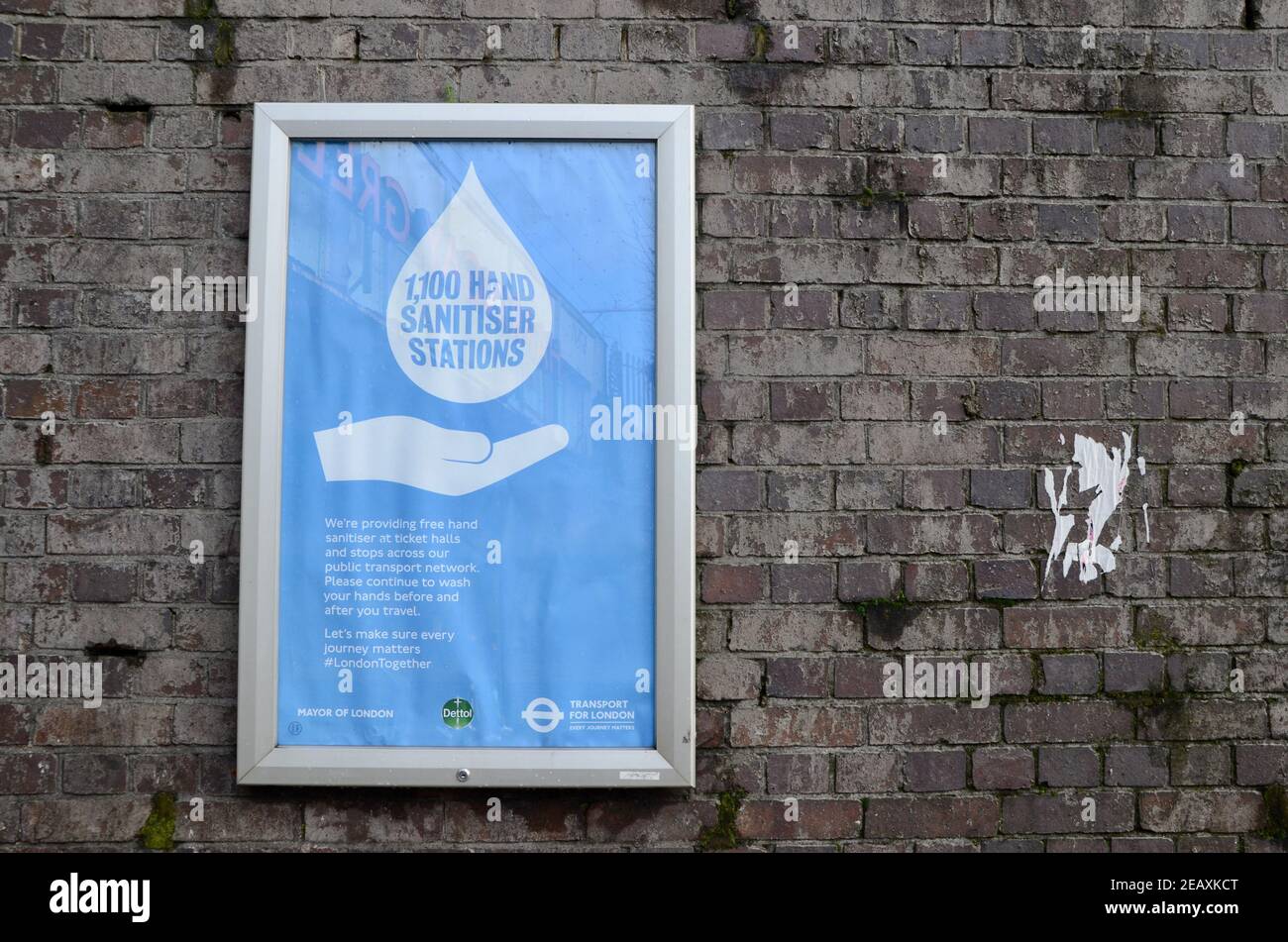 a poster for 1100 hand sanitiser stations at harringay overground station london england uk Stock Photo