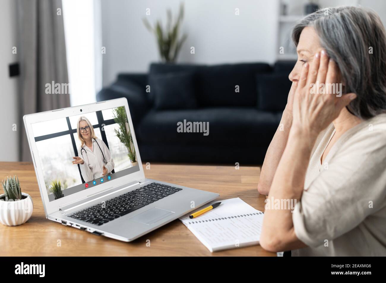 Senior mature woman sits at the table at home have video call with doctor,  using virtual connection on laptop, female patient talks to webcam Stock  Photo - Alamy