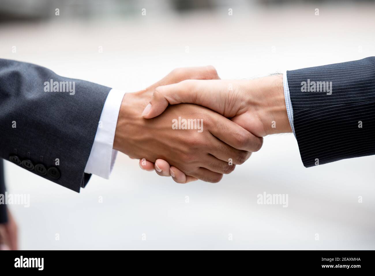 Closed up hands of business partners making firm handshake after meeting for merger and acquisition concept Stock Photo