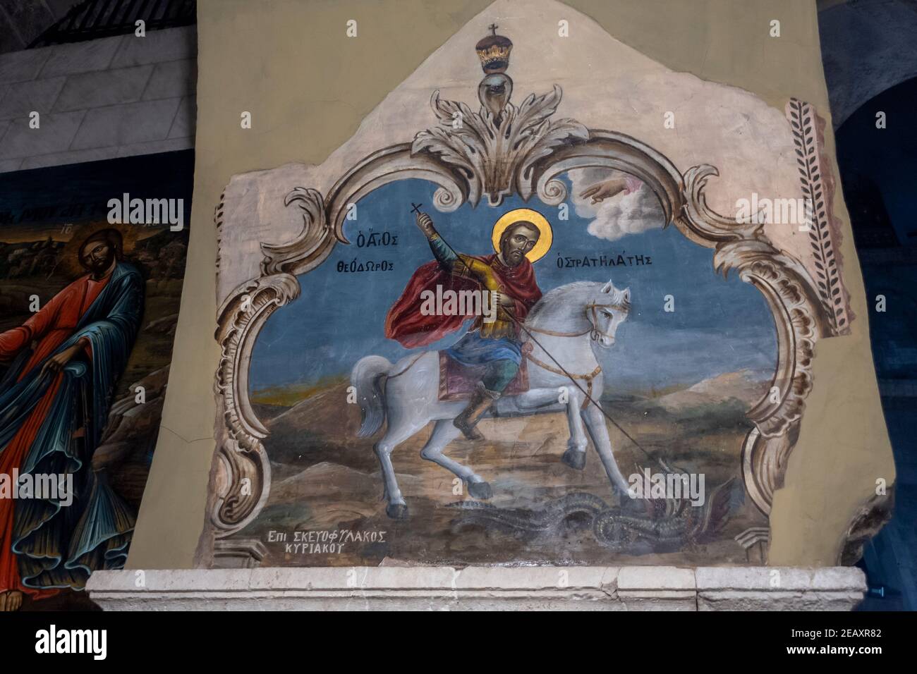 An old painting depicting an orthodox Christian legend in which Saint George slays a dragon that demanded human sacrifices at a northern archway in the Church of Holy Sepulchre in old city of East Jerusalem Israel Stock Photo