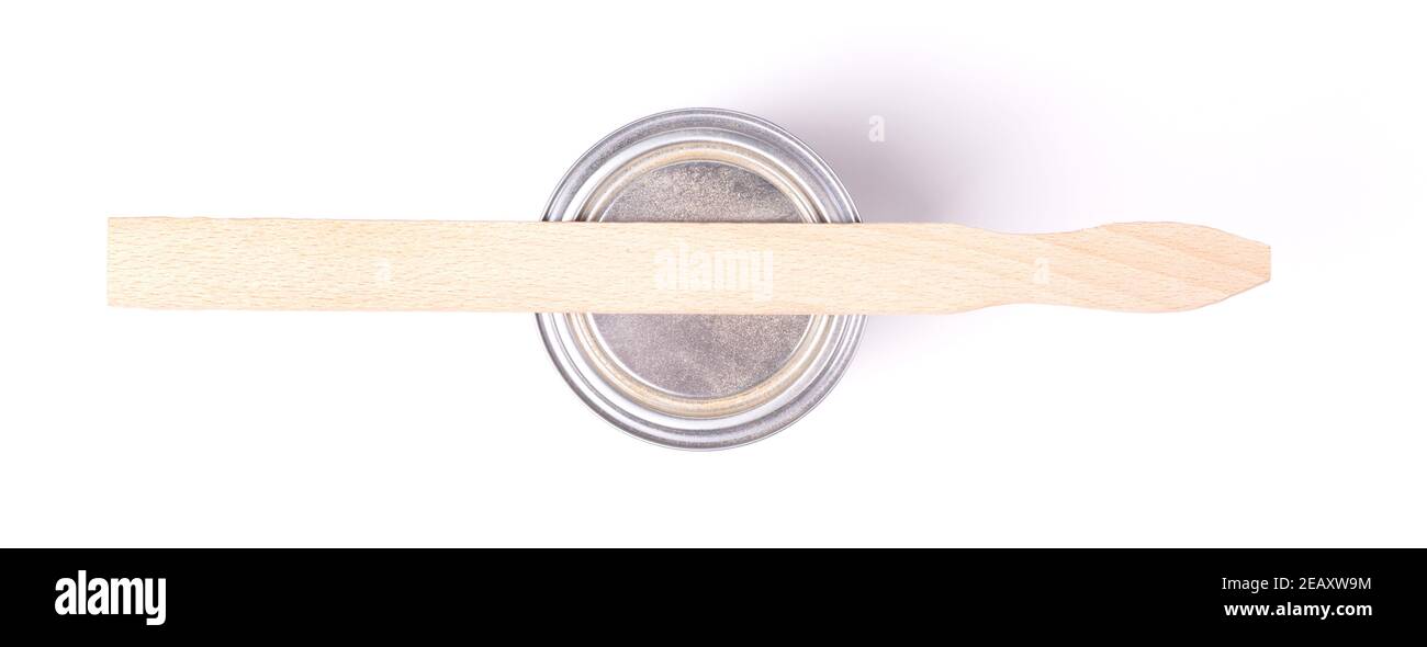 Old stirring stick with a pot of paint, isolated on white Stock Photo