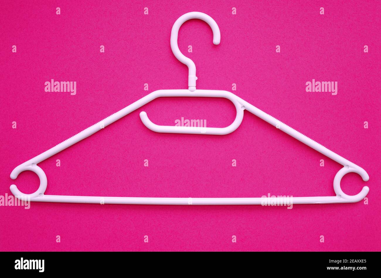 Plastic Clothes Hanger, plastic clotheshanger on pink stylish background. Trendy Shopping and