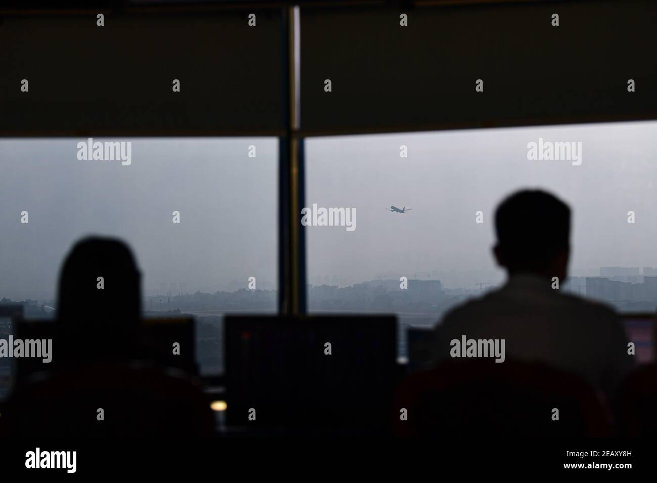 (210211) -- SANYA, Feb. 11, 2021 (Xinhua) -- A plane takes off at the Sanya Phoenix International Airport under the guidance of air traffic controllers in Sanya, south China's Hainan Province, Jan. 28, 2021. Hong Yuan, 29, is an air traffic controller at Sanya Air Traffic Control Tower. As an air traffic controller, Hong is responsible for navigating the air traffic, guiding pilots during takeoff and landing, and monitoring the planes as they travel through the skies. This job requires high attentiveness. Staff members are accordingly supposed to take a break every two hours to recover from Stock Photo