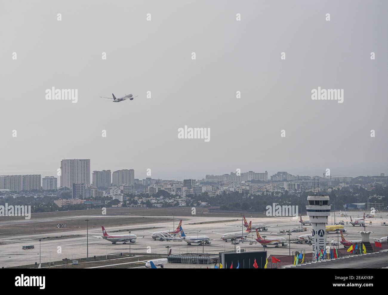 (210211) -- SANYA, Feb. 11, 2021 (Xinhua) -- A plane takes off at the Sanya Phoenix International Airport in Sanya, south China's Hainan Province, Jan. 28, 2021. Hong Yuan, 29, is an air traffic controller at Sanya Air Traffic Control Tower. As an air traffic controller, Hong is responsible for navigating the air traffic, guiding pilots during takeoff and landing, and monitoring the planes as they travel through the skies. This job requires high attentiveness. Staff members are accordingly supposed to take a break every two hours to recover from the intense work. During last year, the a Stock Photo
