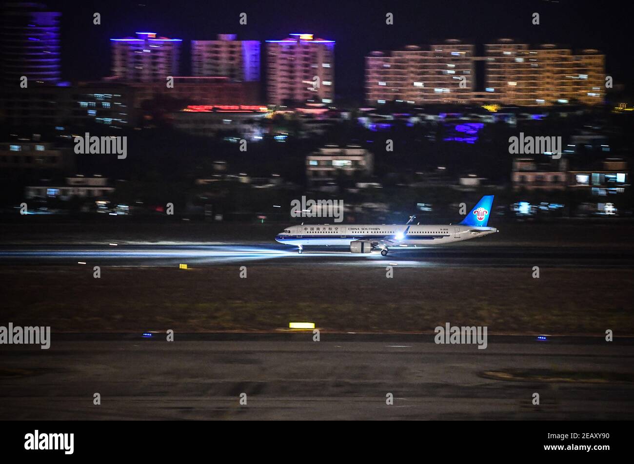 (210211) -- SANYA, Feb. 11, 2021 (Xinhua) -- A plane touches down at the Phoenix International Airport under the guidance of Hong Yuan and his colleagues in Sanya, south China's Hainan Province, Jan. 27, 2021. Hong Yuan, 29, is an air traffic controller at Sanya Air Traffic Control Tower. As an air traffic controller, Hong is responsible for navigating the air traffic, guiding pilots during takeoff and landing, and monitoring the planes as they travel through the skies. This job requires high attentiveness.    Staff members are accordingly supposed to take a break every two hours to recover fr Stock Photo