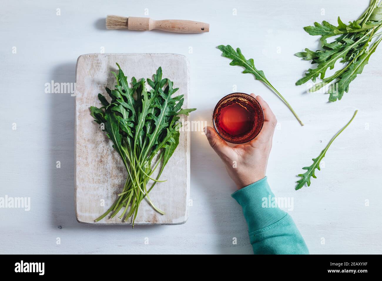 A bunch of fresh rocket leaves on a wooden table Stock Photo