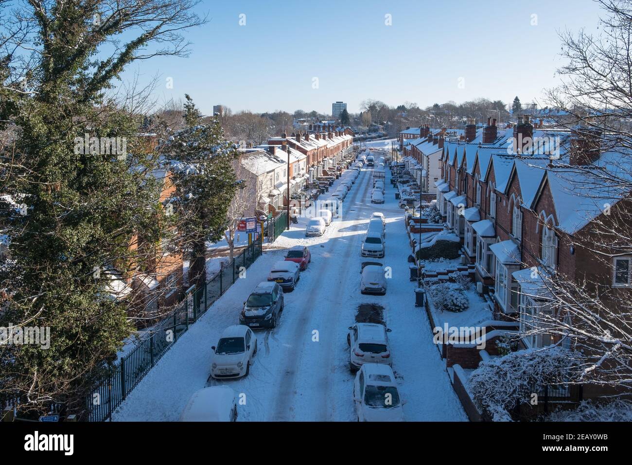View of Snow covered Park Hill Road in Harborne, Birmingham from the walkway over the disused railway bridge Stock Photo