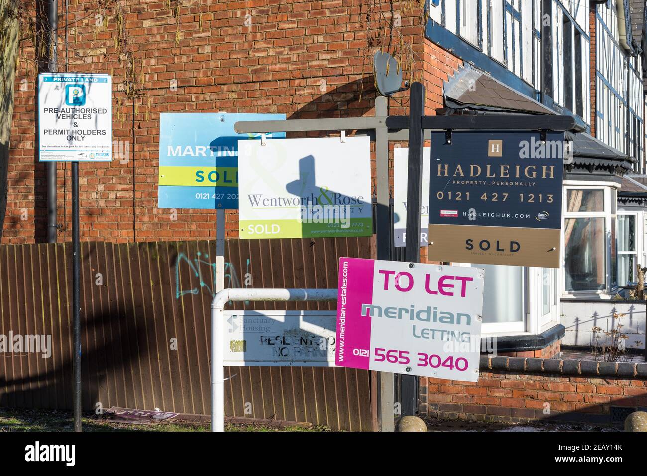 Numerous estate agents for sale and to let signs together in street Stock Photo