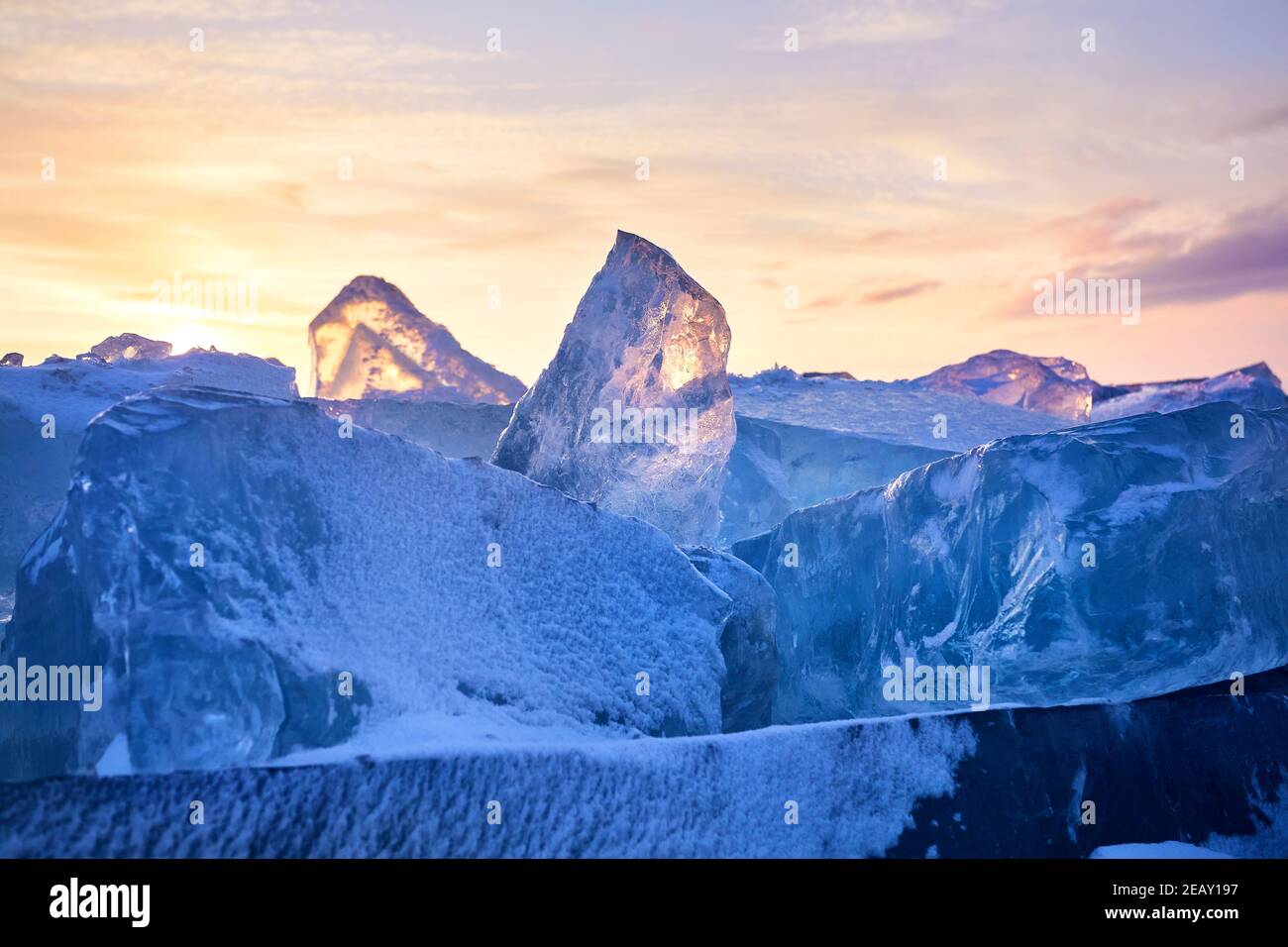 Beautiful landscape of Ice hummock with flare of sunset light at ice of lake Baikal, Russia Stock Photo