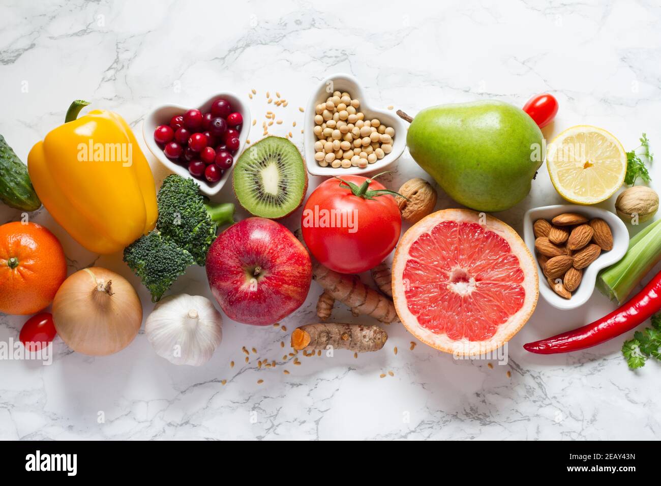 Healthy food selection: fruits, vegetables, seeds, nuts on light background Stock Photo