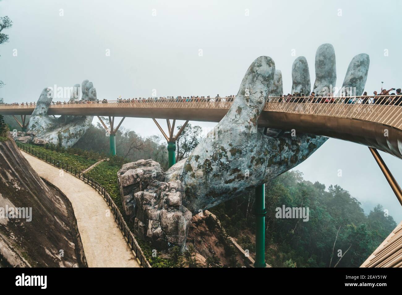 Ba Na Hill mountain resort, Danang city, Vietnam - JANUARY 07, 2019: The Golden Bridge is lifted by two giant hands in the tourist resort on Ba Na Hil Stock Photo