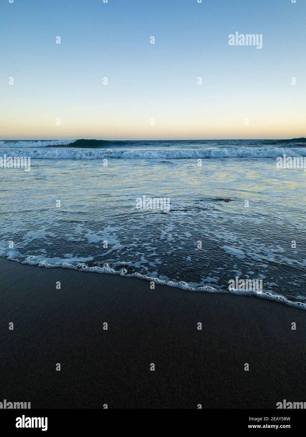 Beautiful black sand beach at sunset. Gran Tarajal, Fuerteventura, Canary Islands. Stock Photo
