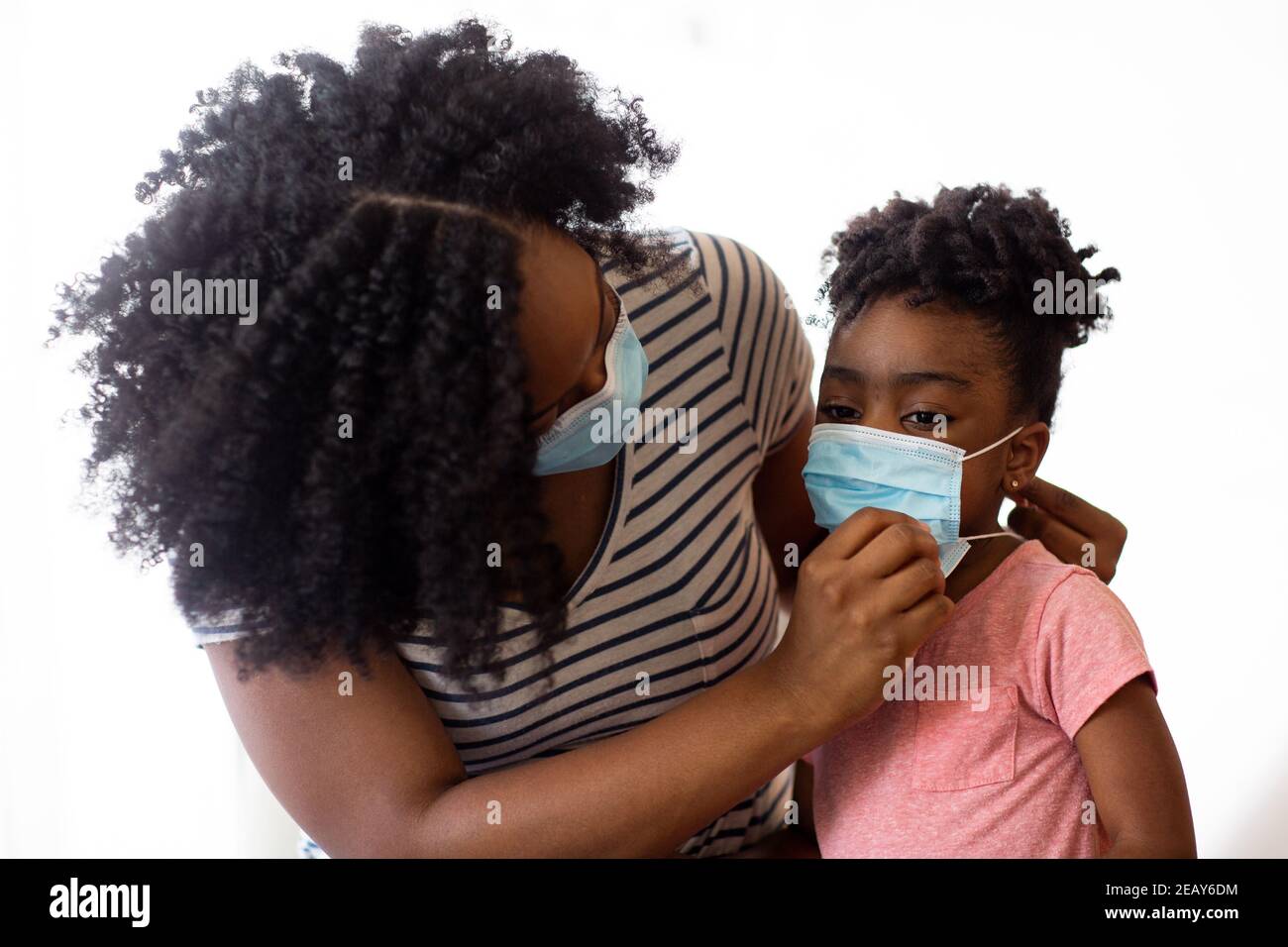 Portrait of an African American woman and her daugher with a face mask. Stock Photo