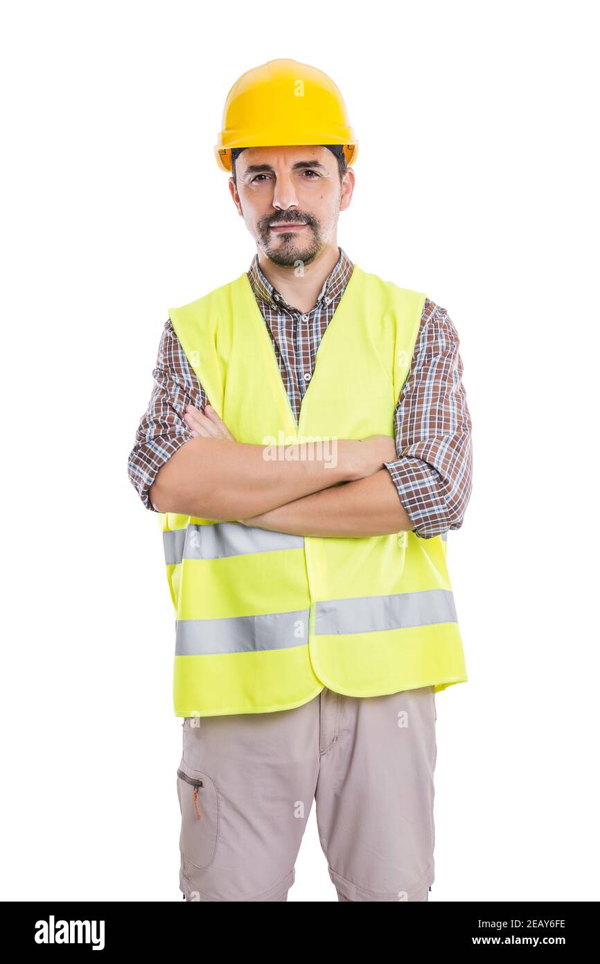 Handsome determined male constructor in hardhat and reflective vest standing with crossed arms on white background and looking at camera Stock Photo