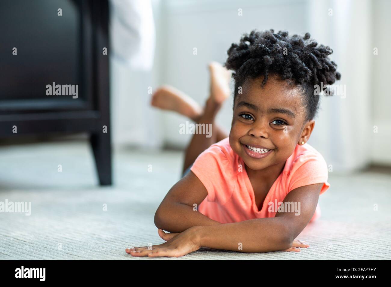 Cute little African American girl smiling and laughing Stock Photo - Alamy