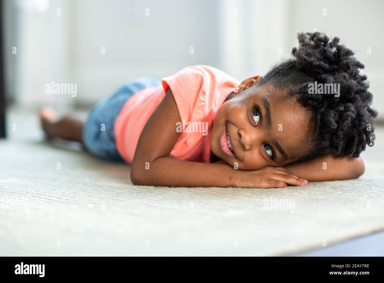 Cute little African American girl smiling and laughing Stock Photo - Alamy