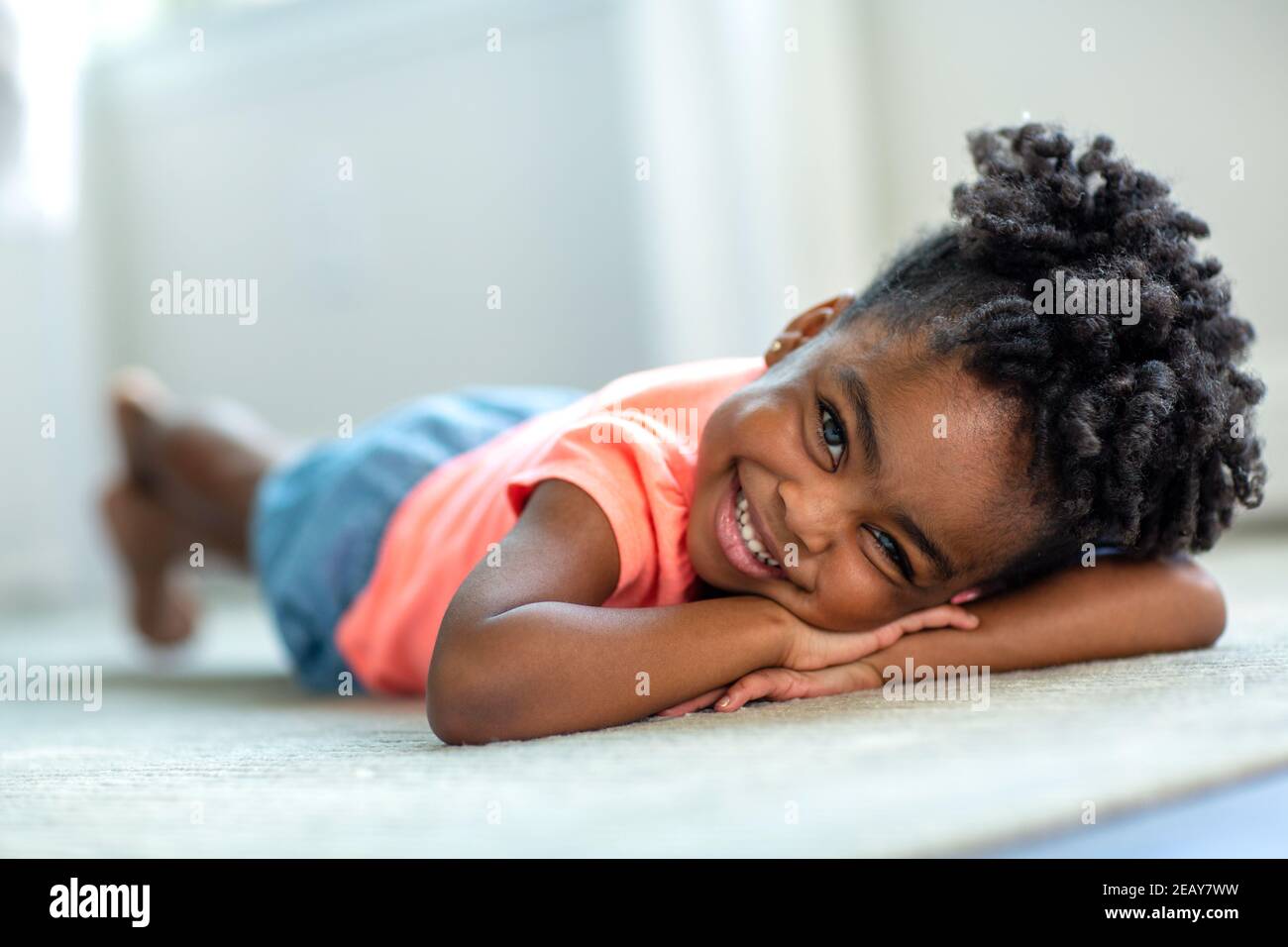 Cute little African American girl smiling and laughing Stock Photo - Alamy