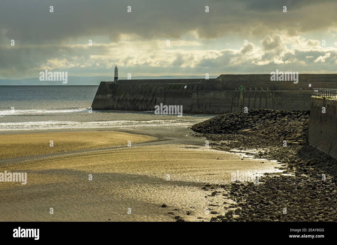 Porthcawl pier and lighthouse guarding the Porthcawl Marina on the South Wales coast. Stock Photo