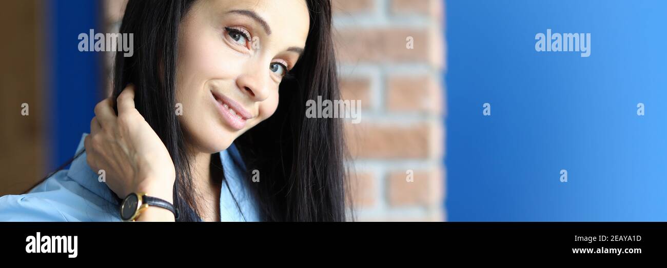Beautiful young woman coquettishly smiles Stock Photo