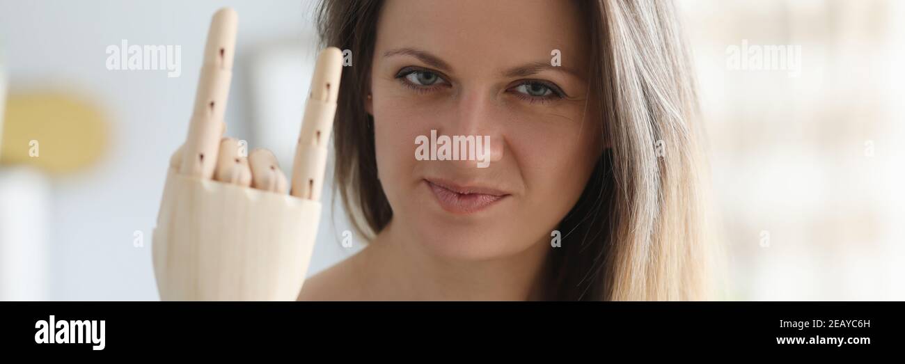 Disabled young woman shows wooden denture gesture portrait Stock Photo
