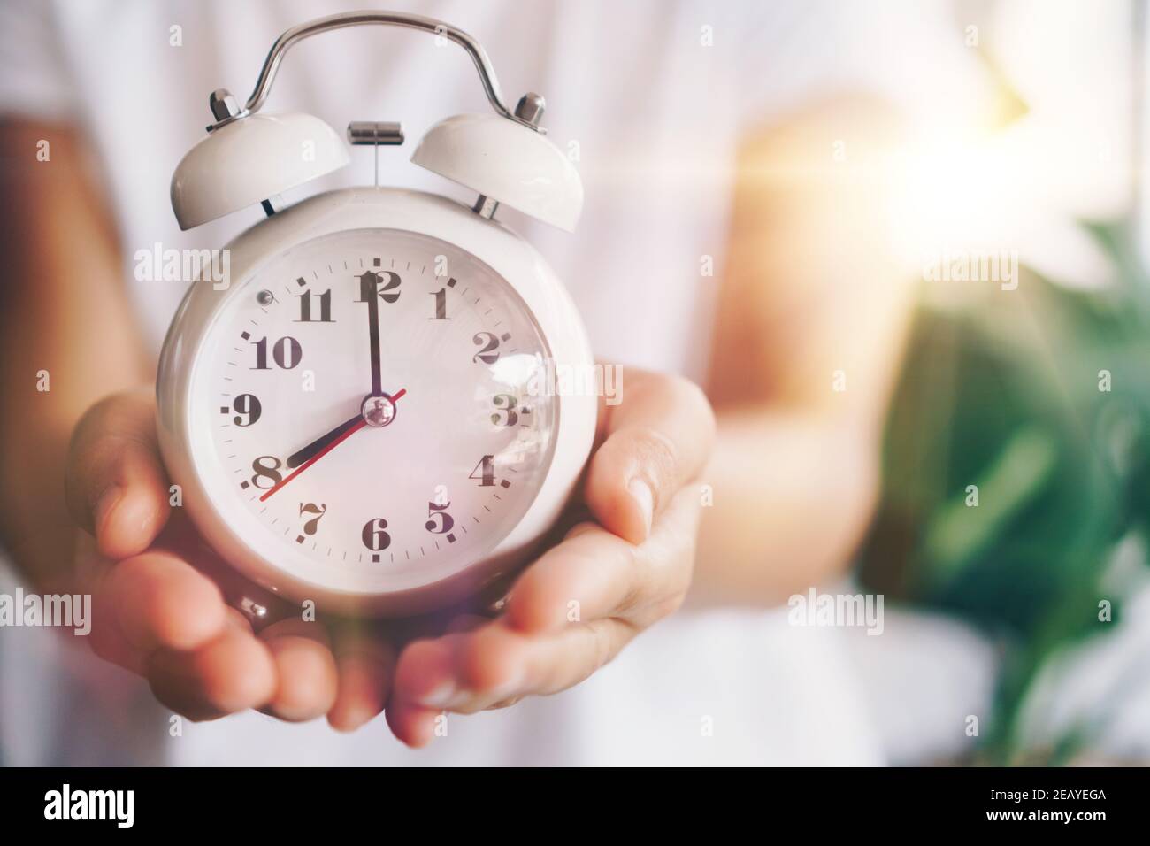 Selective focus of alarm clock with nature bokeh background. lifestyle  productive life concept. Stock Photo