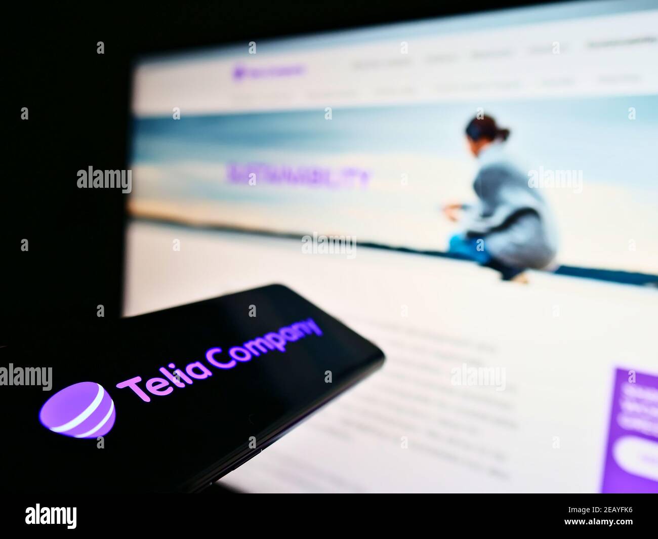 Mobile phone with business logo of Swedish telecommuncations provider Telia Company AB on screen in front of website. Focus on cellphone display. Stock Photo