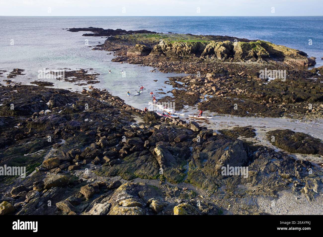 A group of kayakers heading back to Niarbyl beach after paddling round the tail rocks Stock Photo