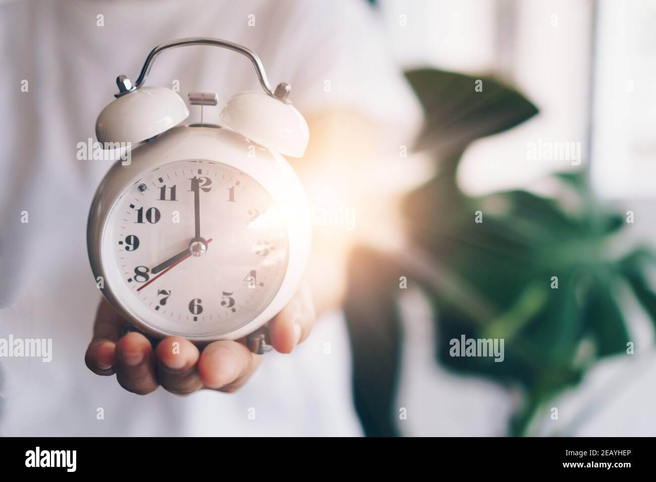 Selective focus of alarm clock with nature bokeh background. lifestyle  productive life concept. Stock Photo