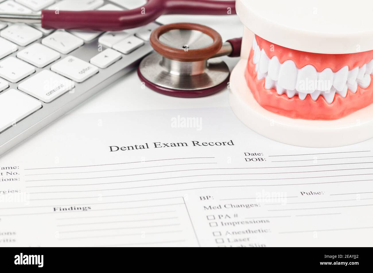 Dental exam record and model teeth with stethoscope medical on work table. Stock Photo