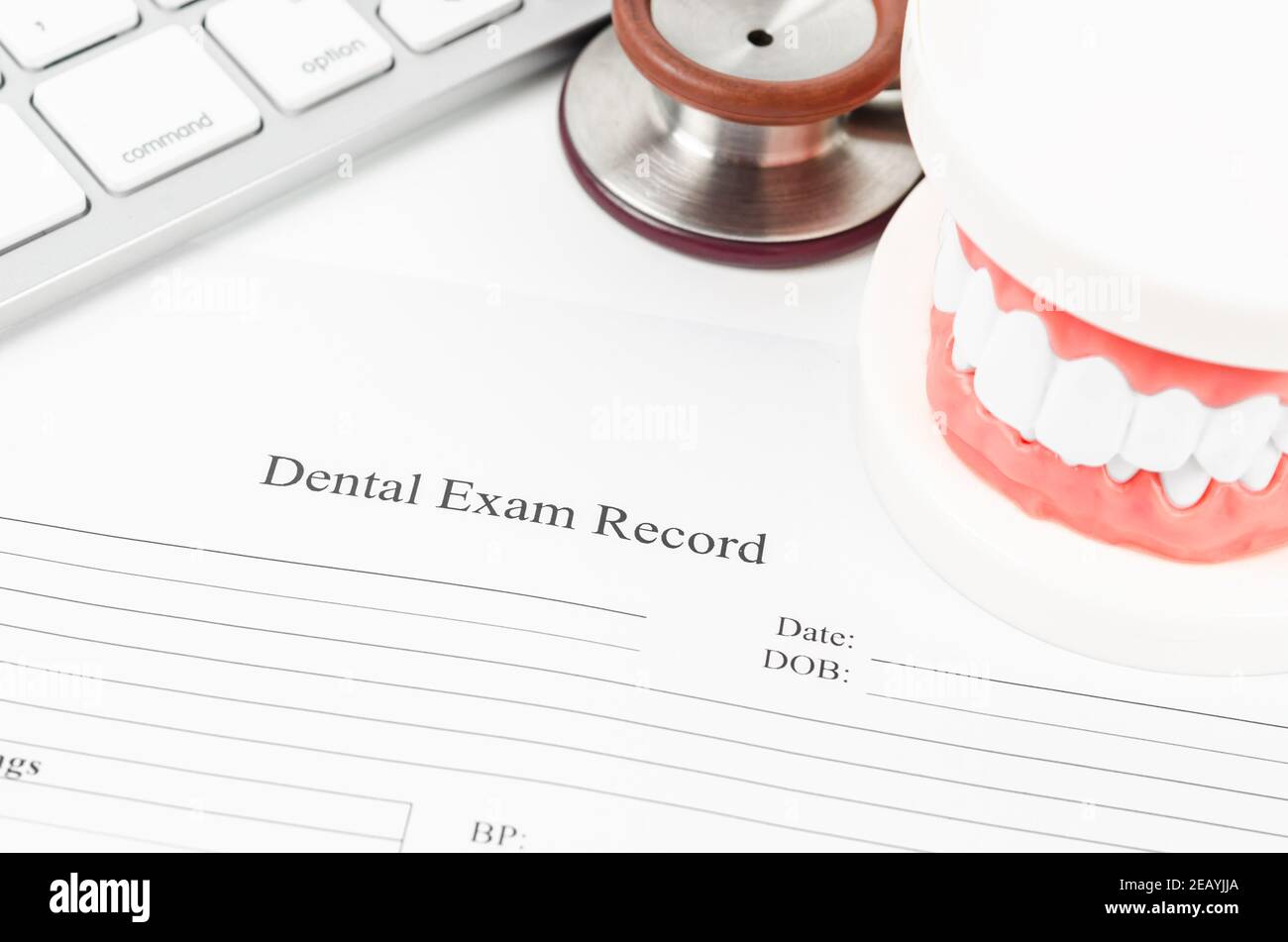 Dental exam record and model teeth with stethoscope medical on work table. Stock Photo
