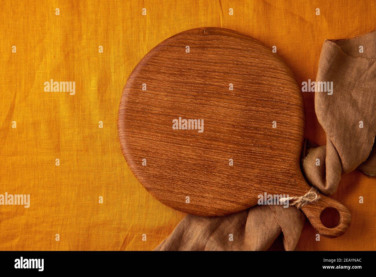 Download Food Background Mockup With Round Wooden Cutting Board On Yellow Mustard Linen Textile Tablecloth Stock Photo Alamy
