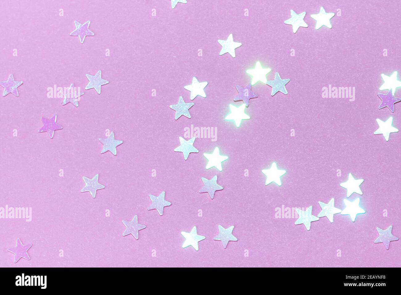 Delicate pink background with stars. The concept of femininity, fragility, women's day, the Day of St. Valentine, Christmas, New Year, holiday, birthday, etc. Stock Photo