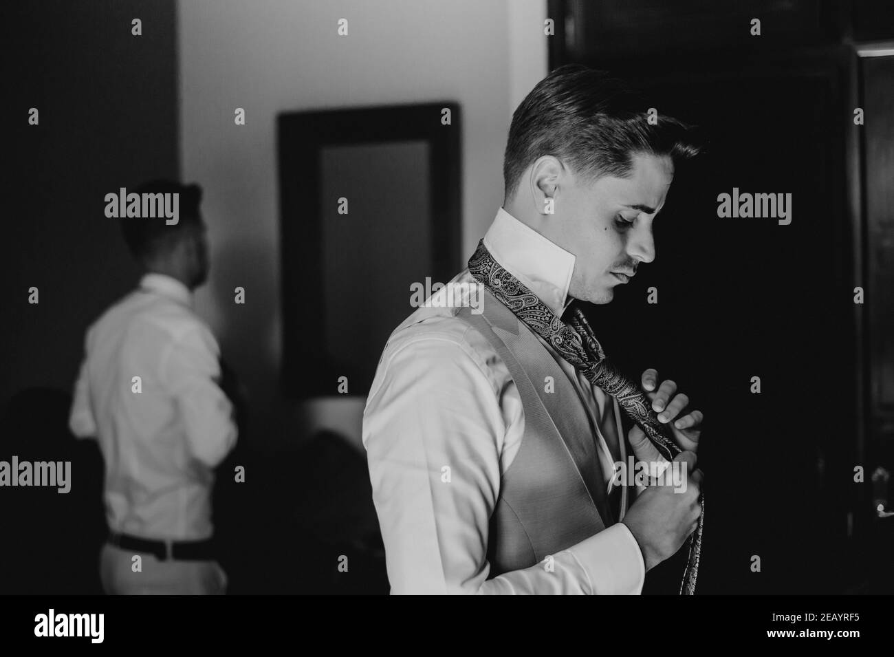 Groom and best man putting on the suit before the wedding Stock Photo