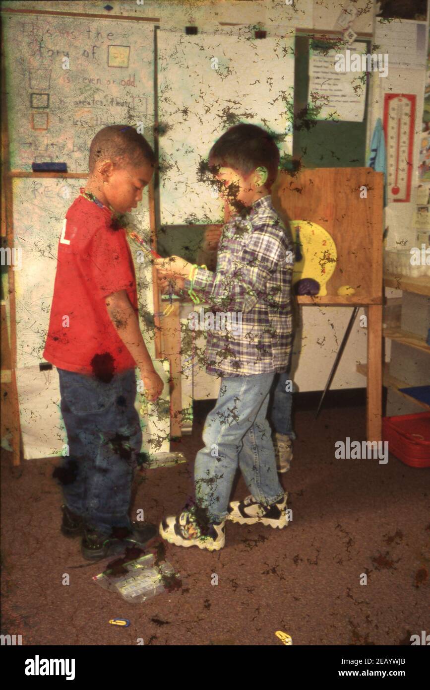 HORSEPLAY: k-1st grade boys play rough in school Walnut Creek Elementary Austin ©2001  November BAD4261G Stock Photo