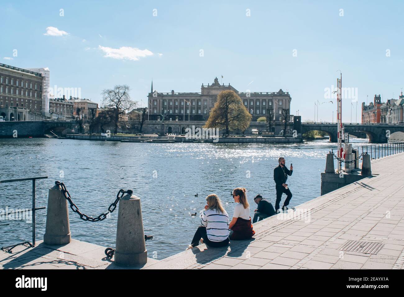 Stockholm, Sweden - May 1, 2019 : Scenic sunny day panorama of Stockholm city center. Tourists and citizens enjoying sunny day at Stockholm quay Stock Photo