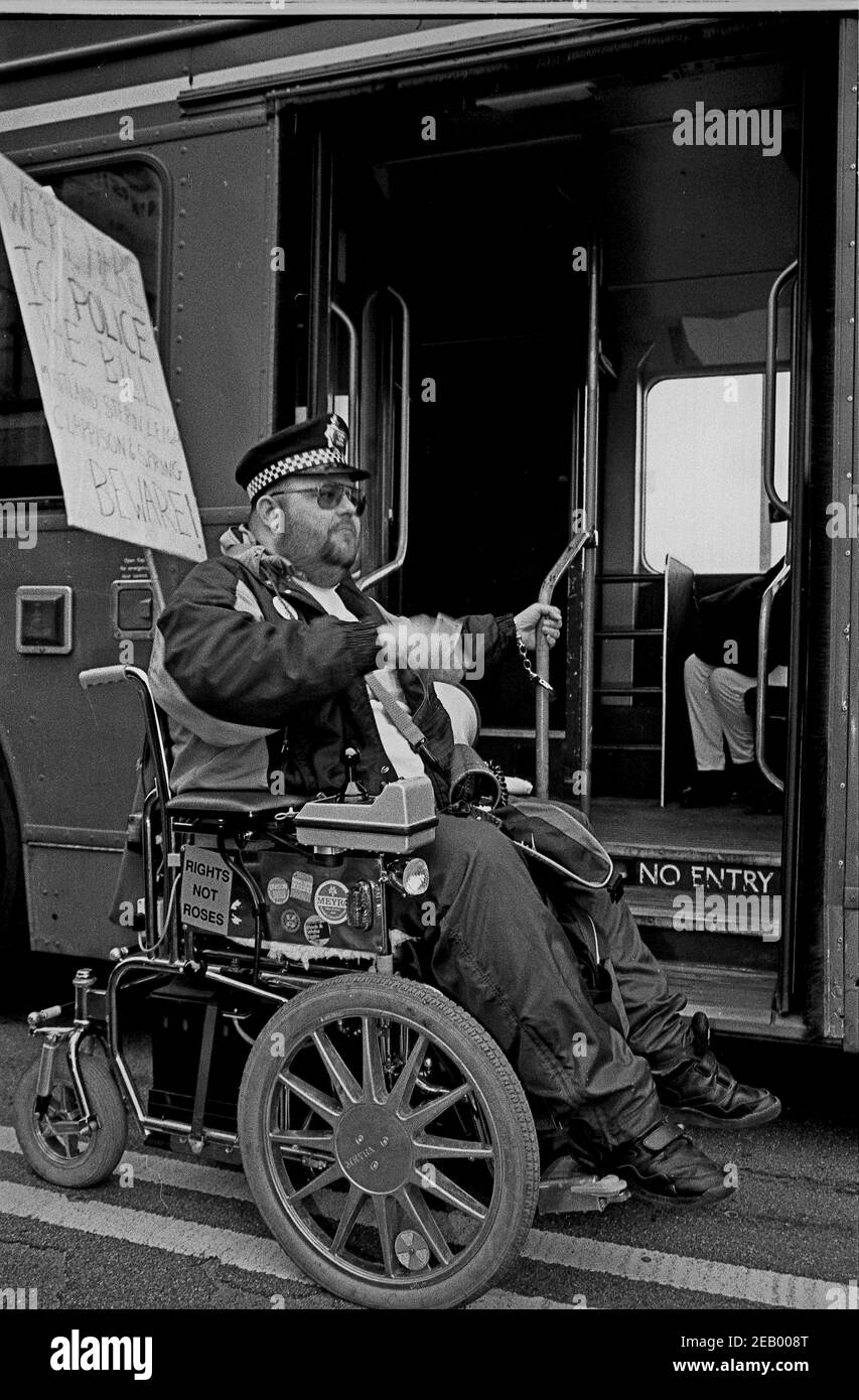 A wheelchair user from DAN (Disabled Action Network) handcuffs themselves to a London bus on Westminster Bridge, London in  February 1995 as part of a series of protests about lack of disabled persons access to public transport, in the lead up to the Disability Discrimination Act being debated in Parliament. Stock Photo