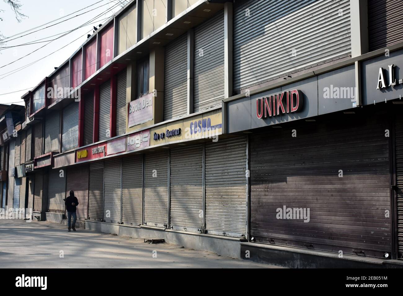 a-man-walks-along-a-closed-market-during-the-shutdown-to-mark-the-37th