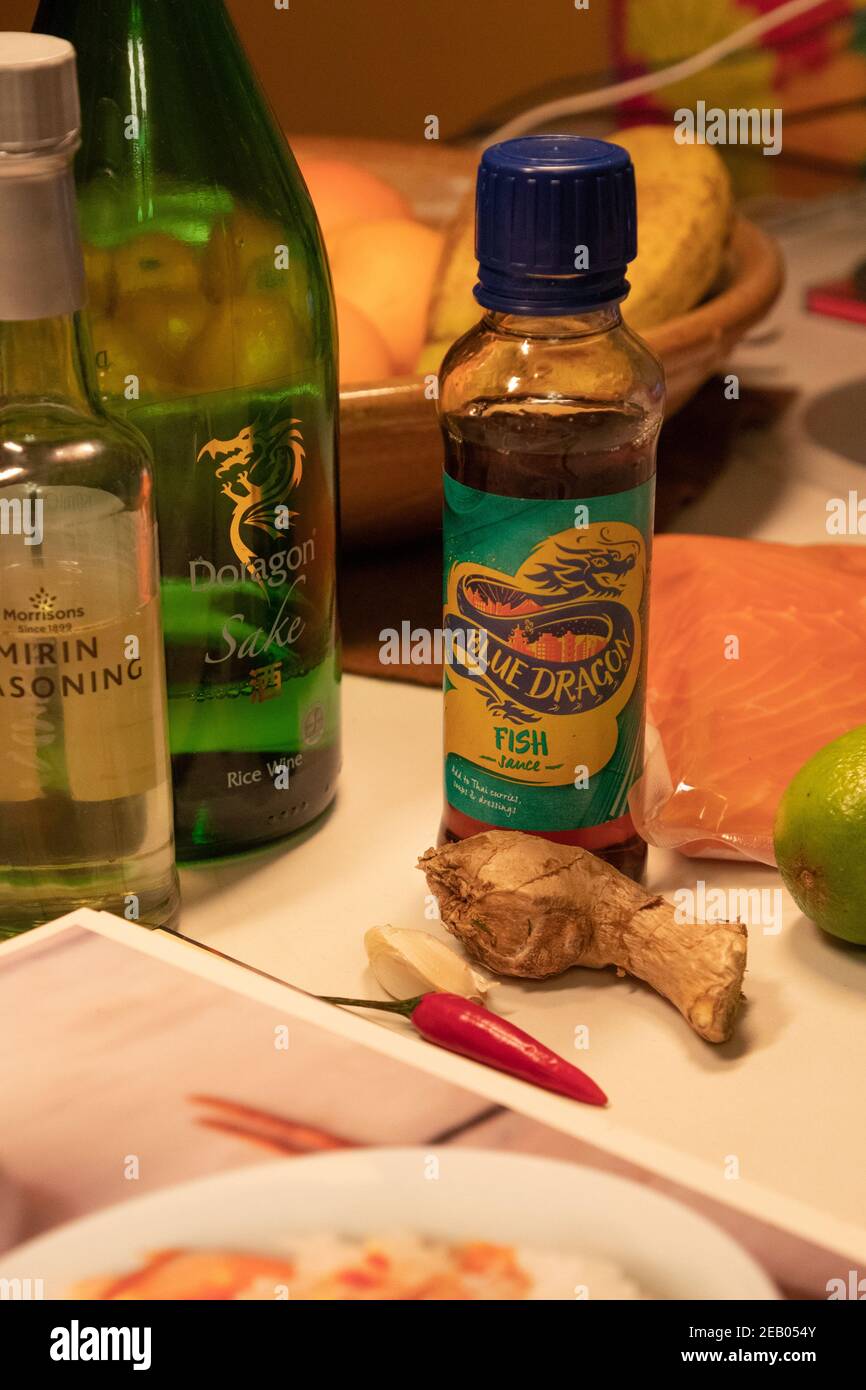 In a family kitchen, ingredients are assembled in preparation for cooking 'Salmon and sushi rice' from Nigella Lawson's 'Kitchen' cook book. Stock Photo