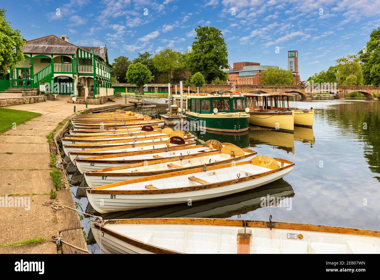 Rowing boats moored on the River Avon with the RSC Theatre and Tramway in the background, Stratford Upon Avon, England Stock Photo