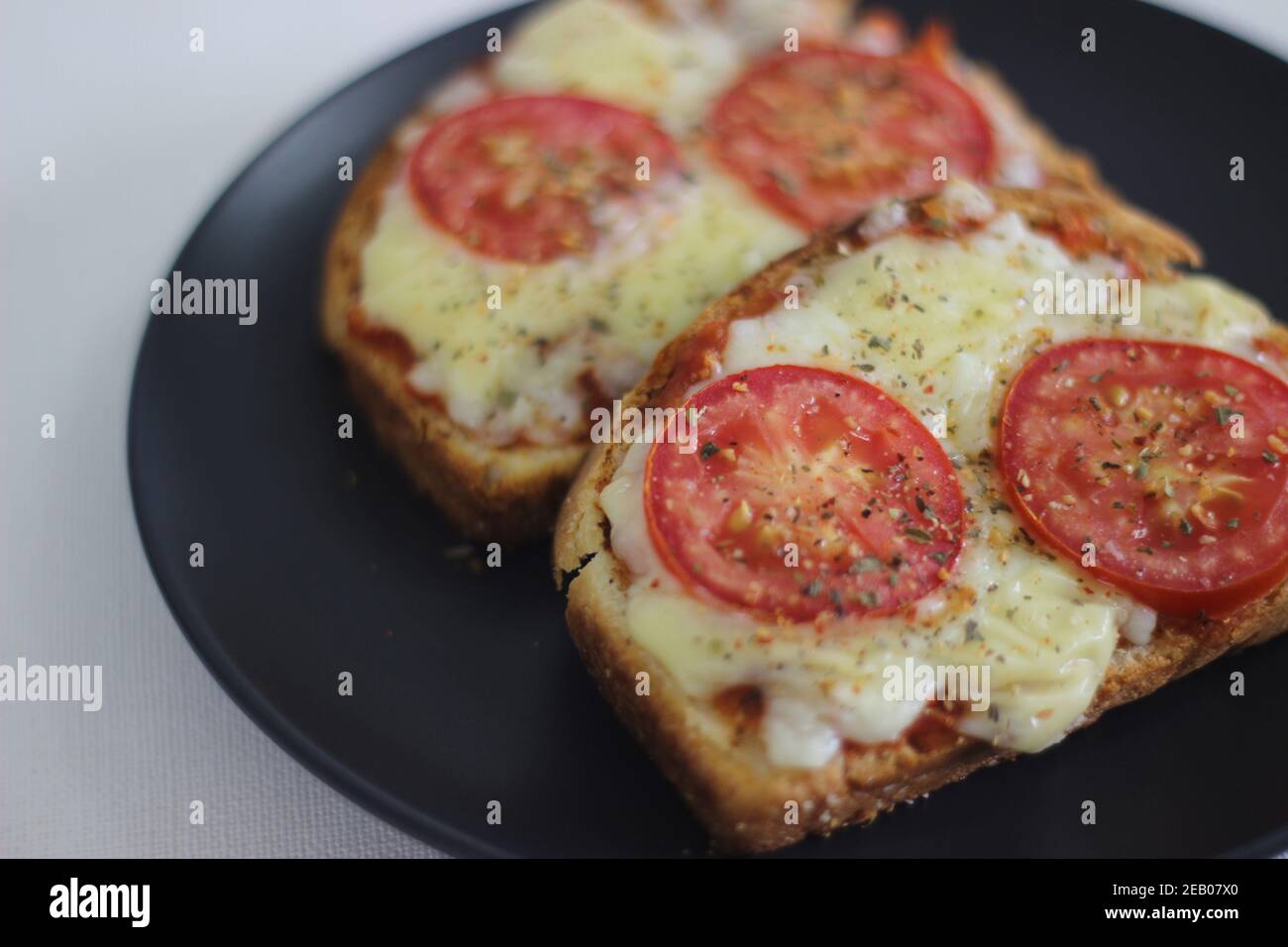 Pizza toast with home baked bread loaf. Shot on white background. Stock Photo